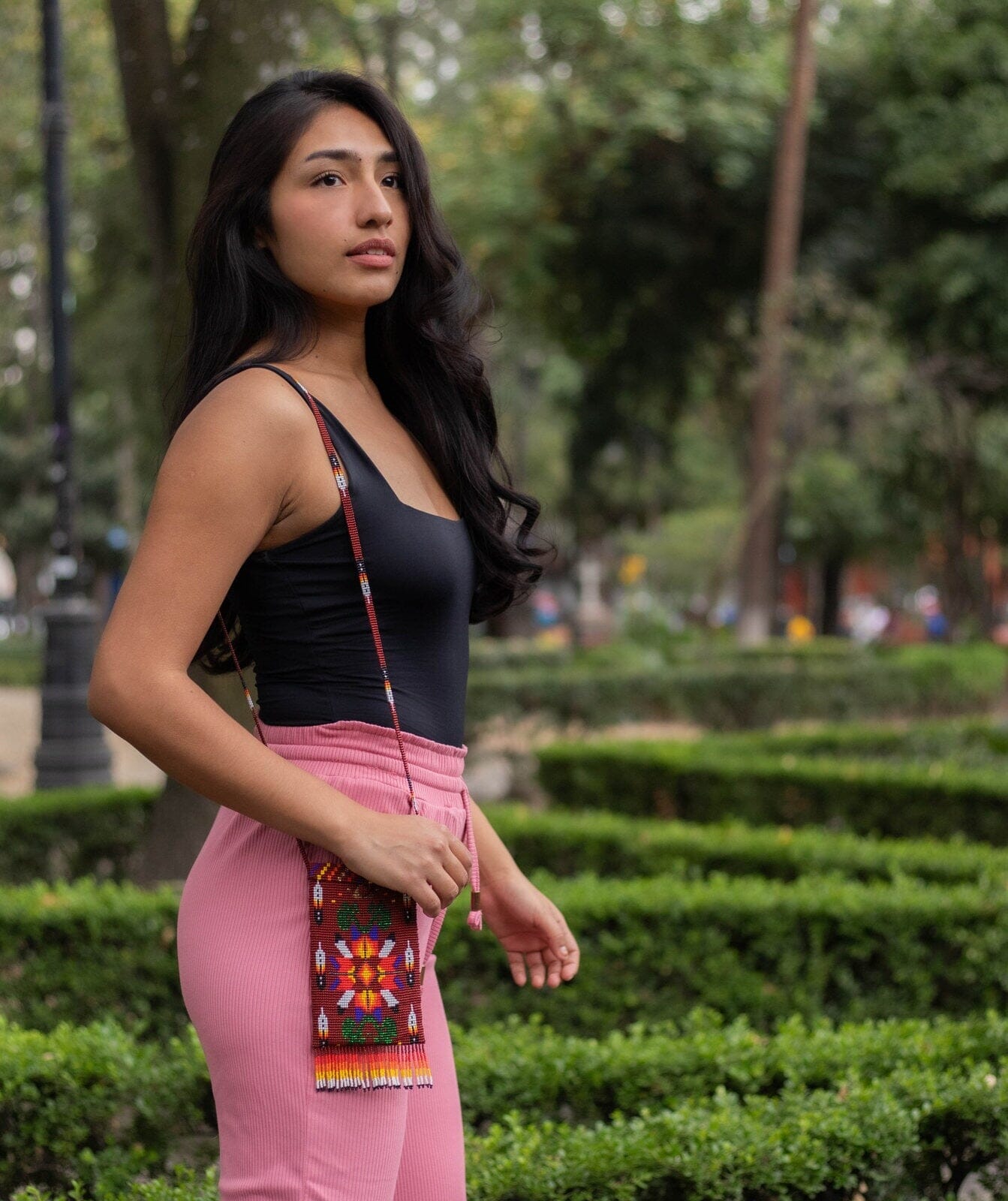 woman wearing big bear brown orange red yellow white blue green beaded purse bag satchel fringe native american jewelry