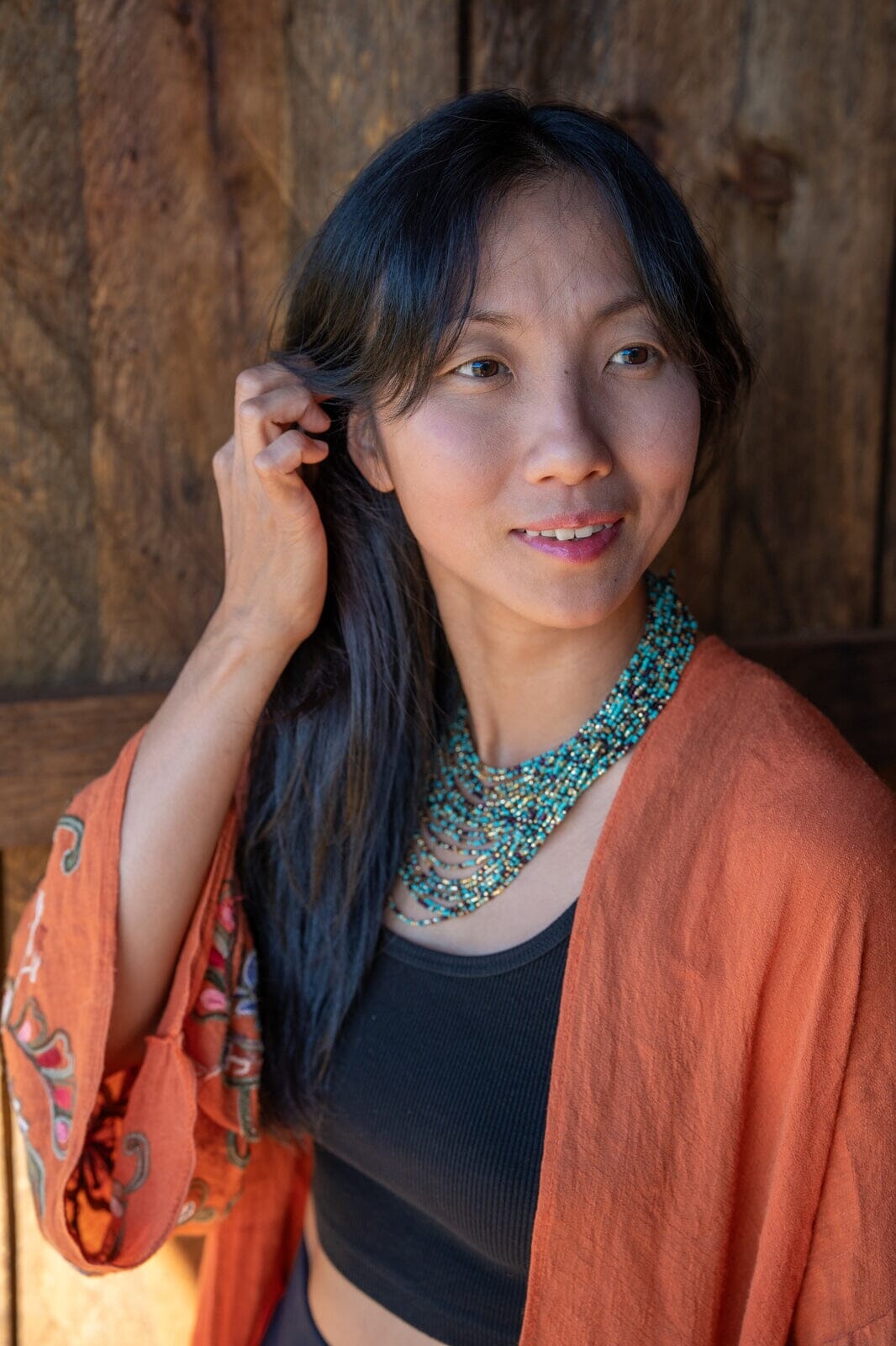 woman wearing Blue Pebbles beaded multi-strand Necklace turquoise black gold native american jewelry Mother Sierra