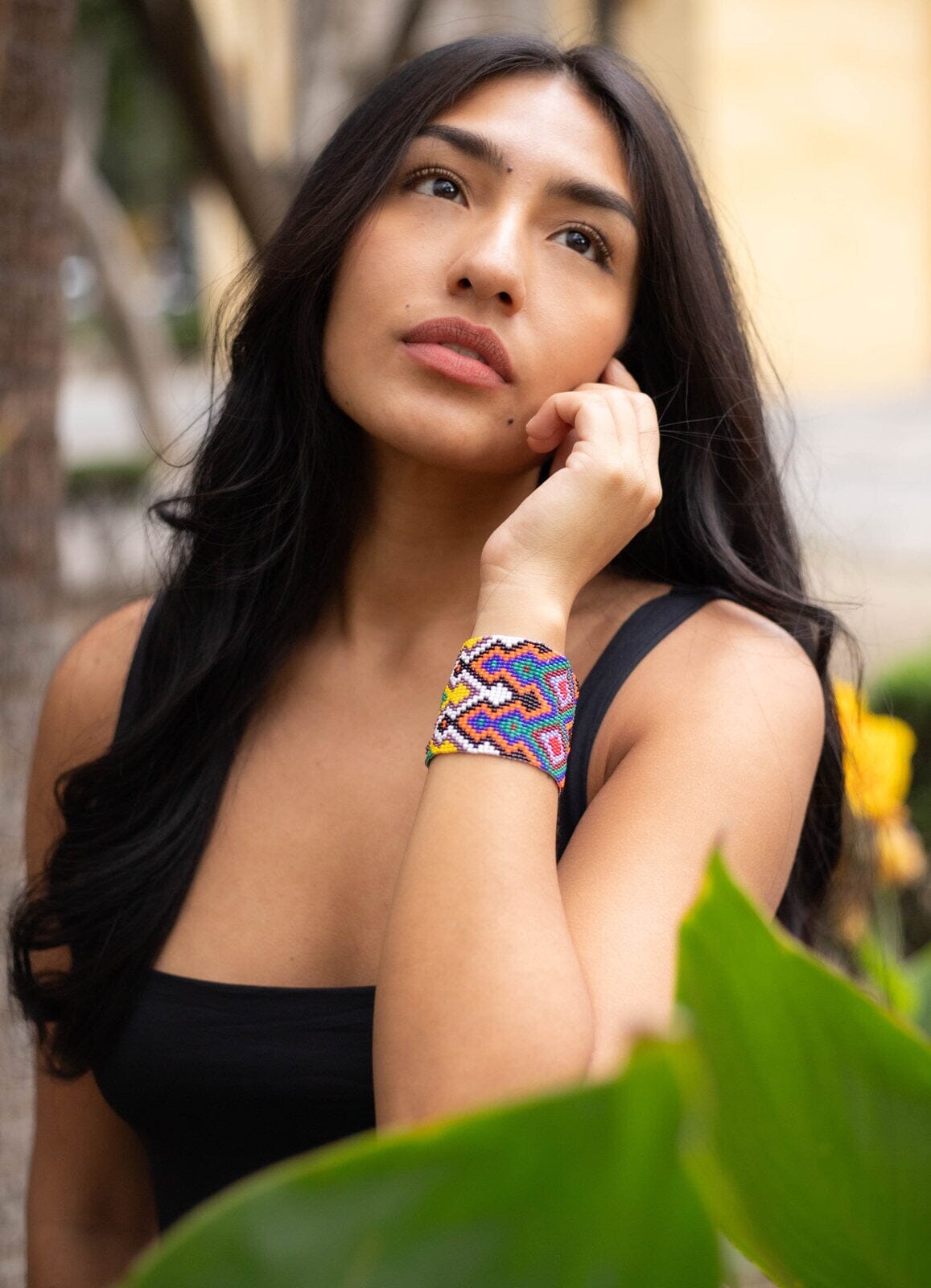 woman wearing Far Out White, Yellow, Orange, Blue, Green, Red, Purple beaded bracelet cuff