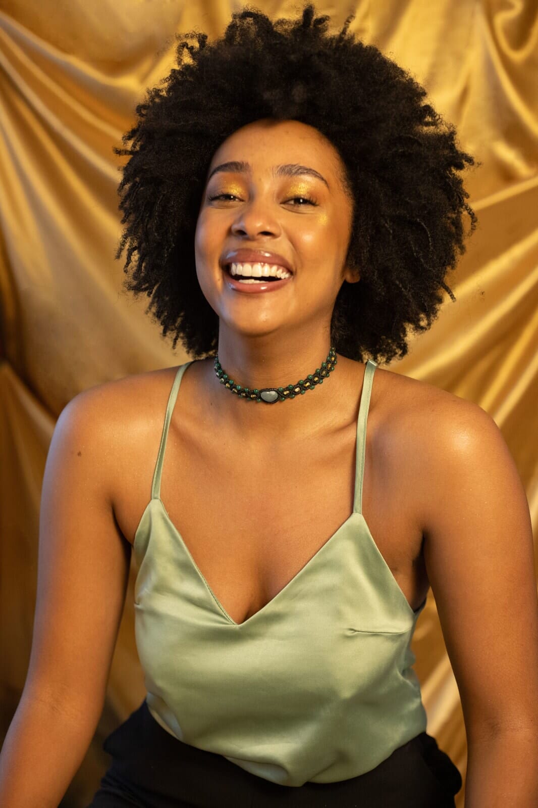 woman smiling wearing Little Heart Macrame Choker Necklaces Mother Sierra handmade jewelry handcrafted jade amber teal stone macrame cord