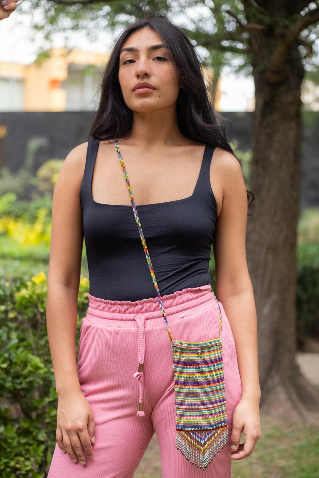 woman wearing madagascar red orange yellow green blue beaded purse bag satchel fringe native american jewelry