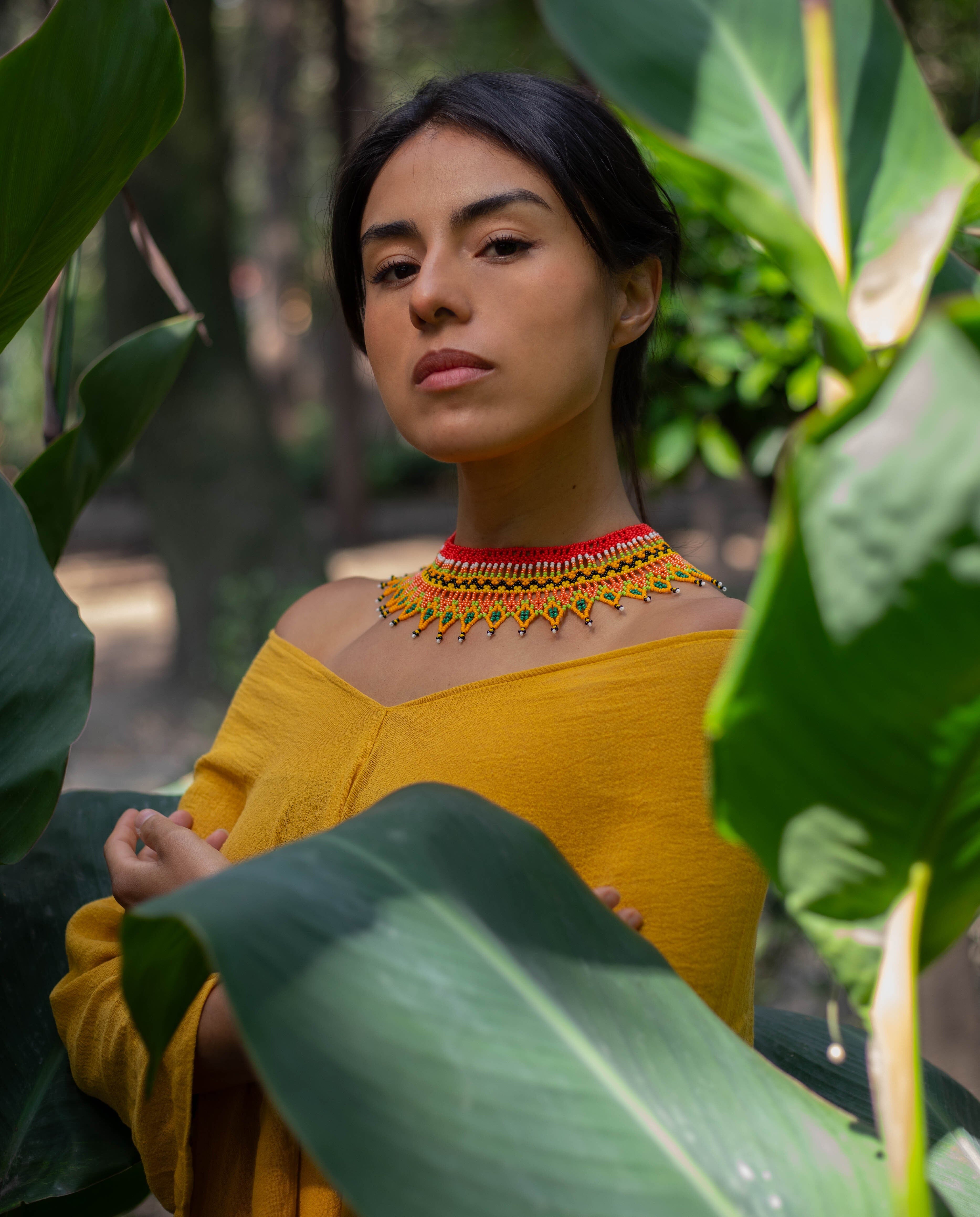 woman wearing red yellow white black green makeda queen of sheba choker a handmade beaded necklace tribal native american jewelry
