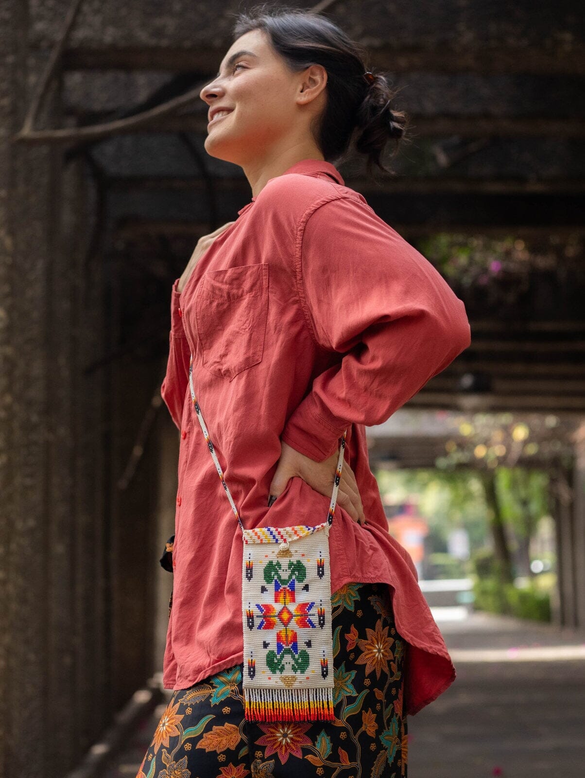 woman wearing off white bright orange red sunset mustang beaded bag satchel purse