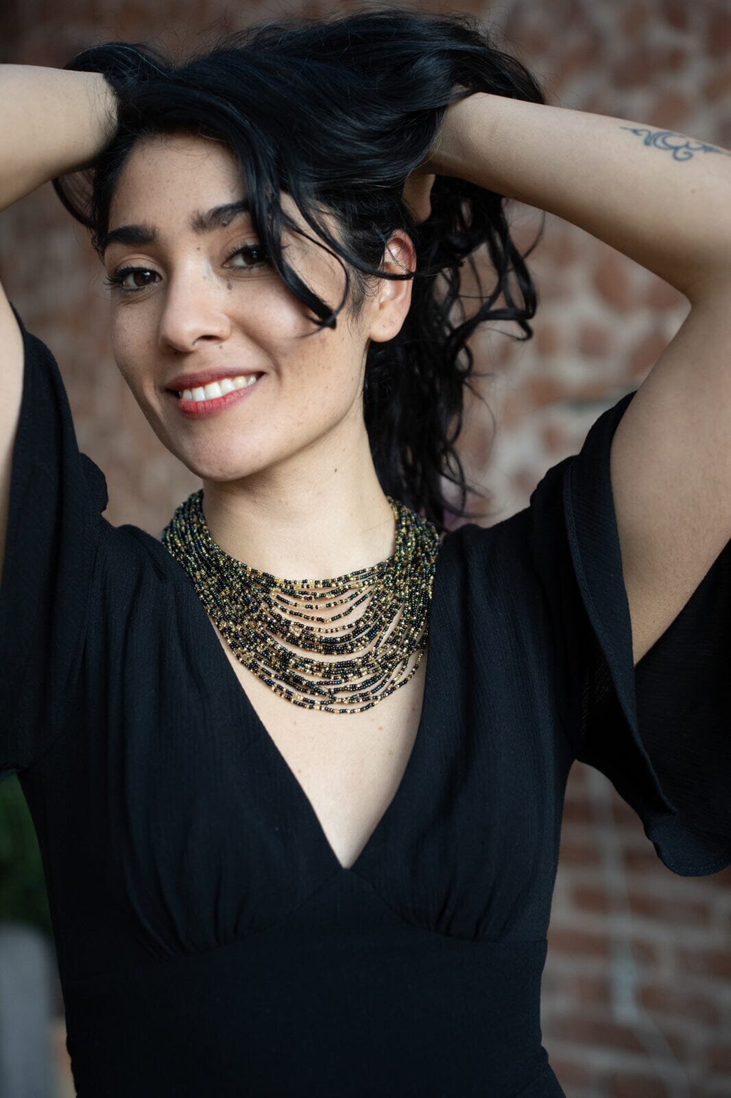 woman wearing On The Rocks beaded Necklace multi-strand black gold native american jewelry Mother Sierra