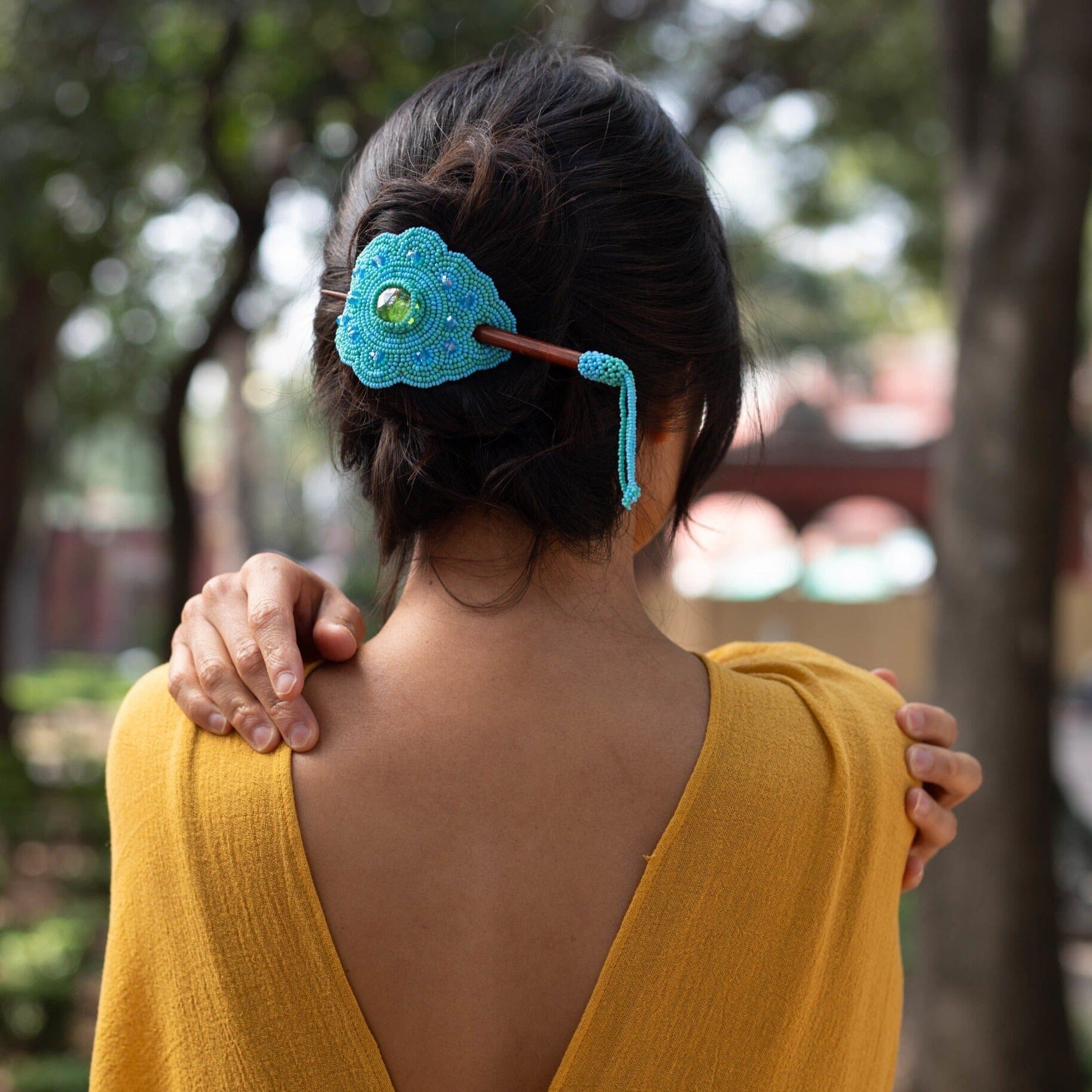 woman wearing sea foam light blue beaded hair barrette and pin statement piece native american jewelry