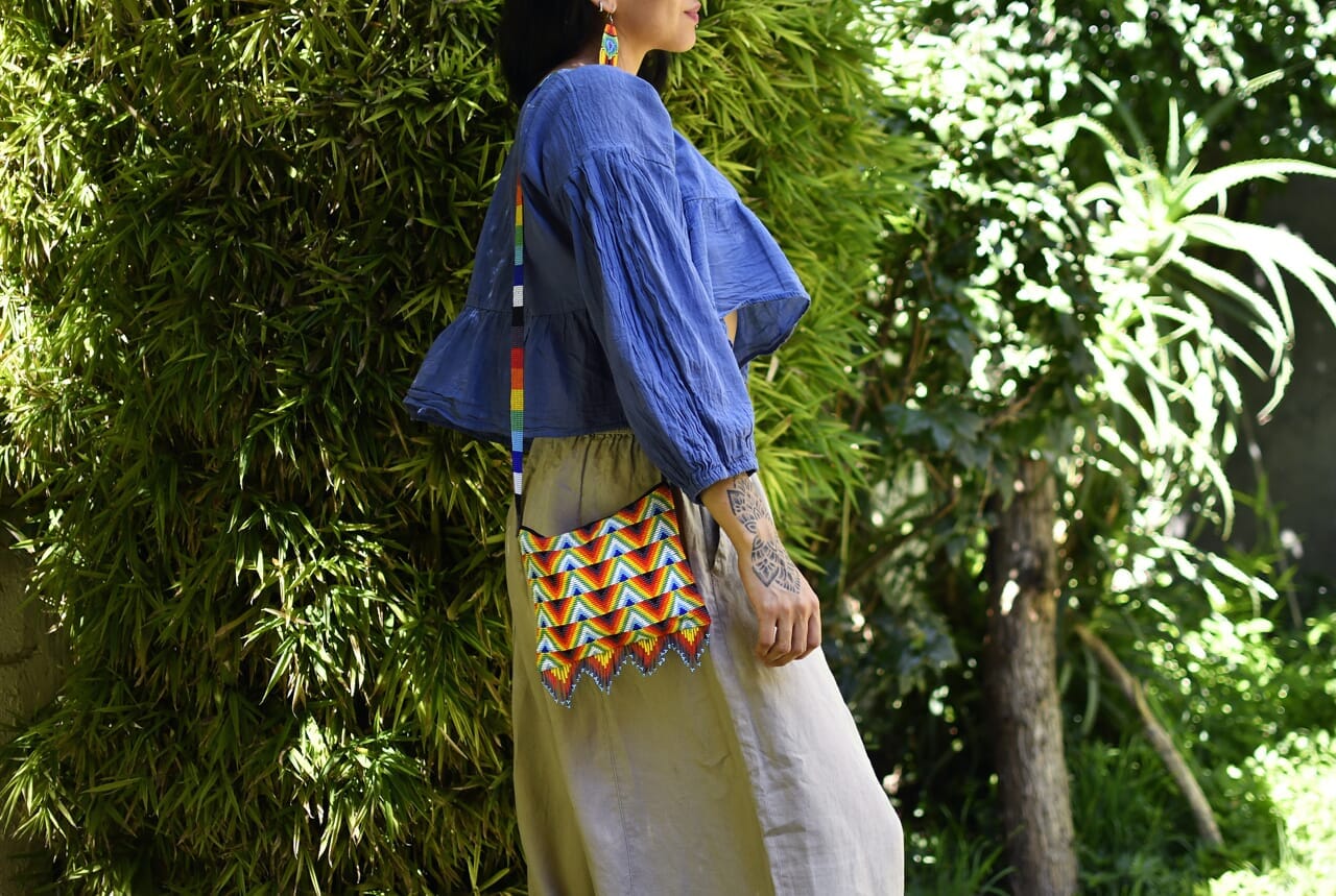 woman wearing balderdash Rainbow Red, Orange, Yellow, Green, Blue, White beaded purse bag fringe