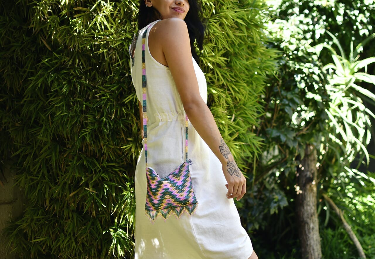 woman wearing gold pink teal green beaded purse bag fringe