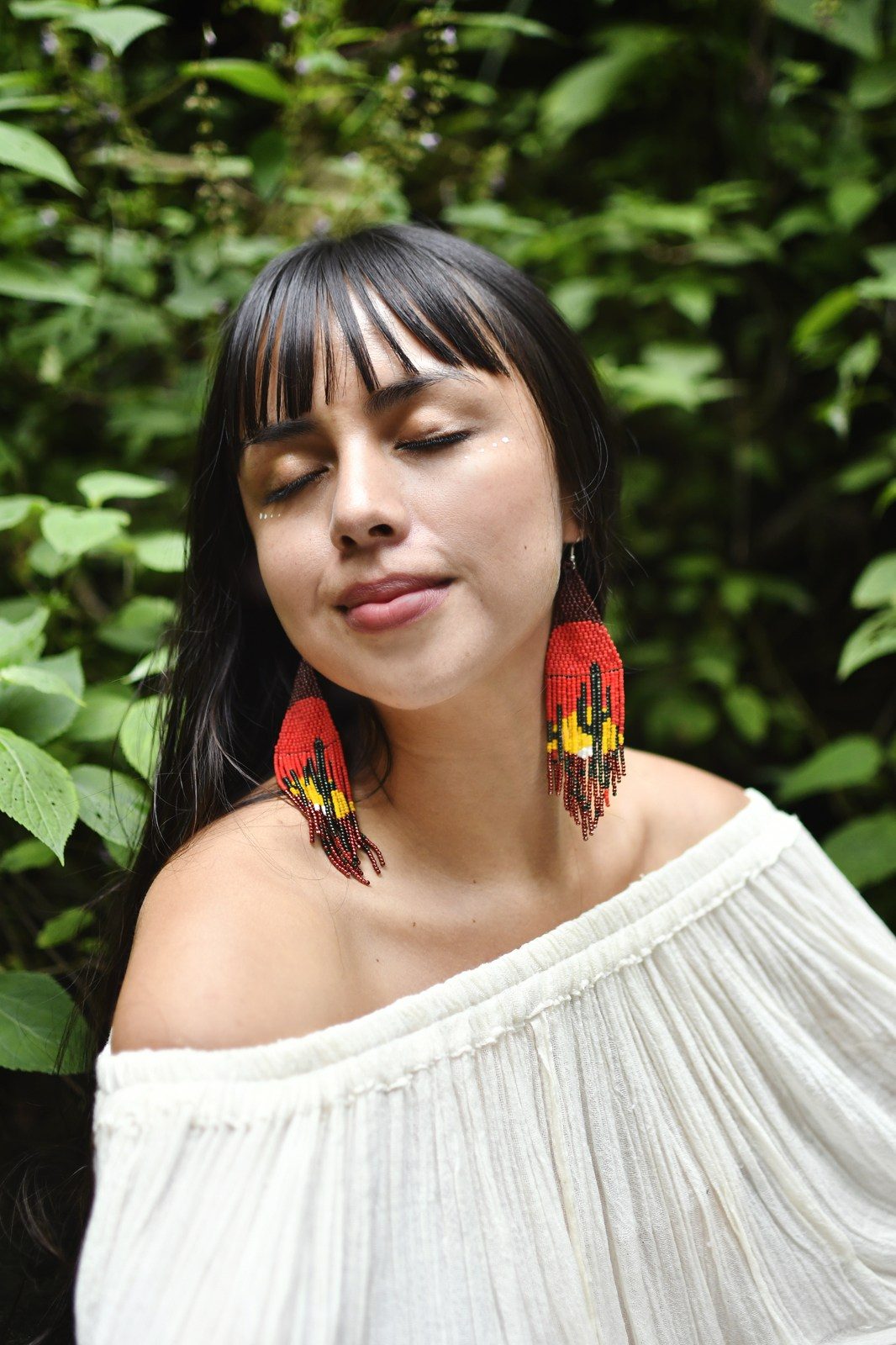 Woman Wearing a Handmade Death Valley Sunset Cactus Fringe Beaded Earrings by Mother Sierra