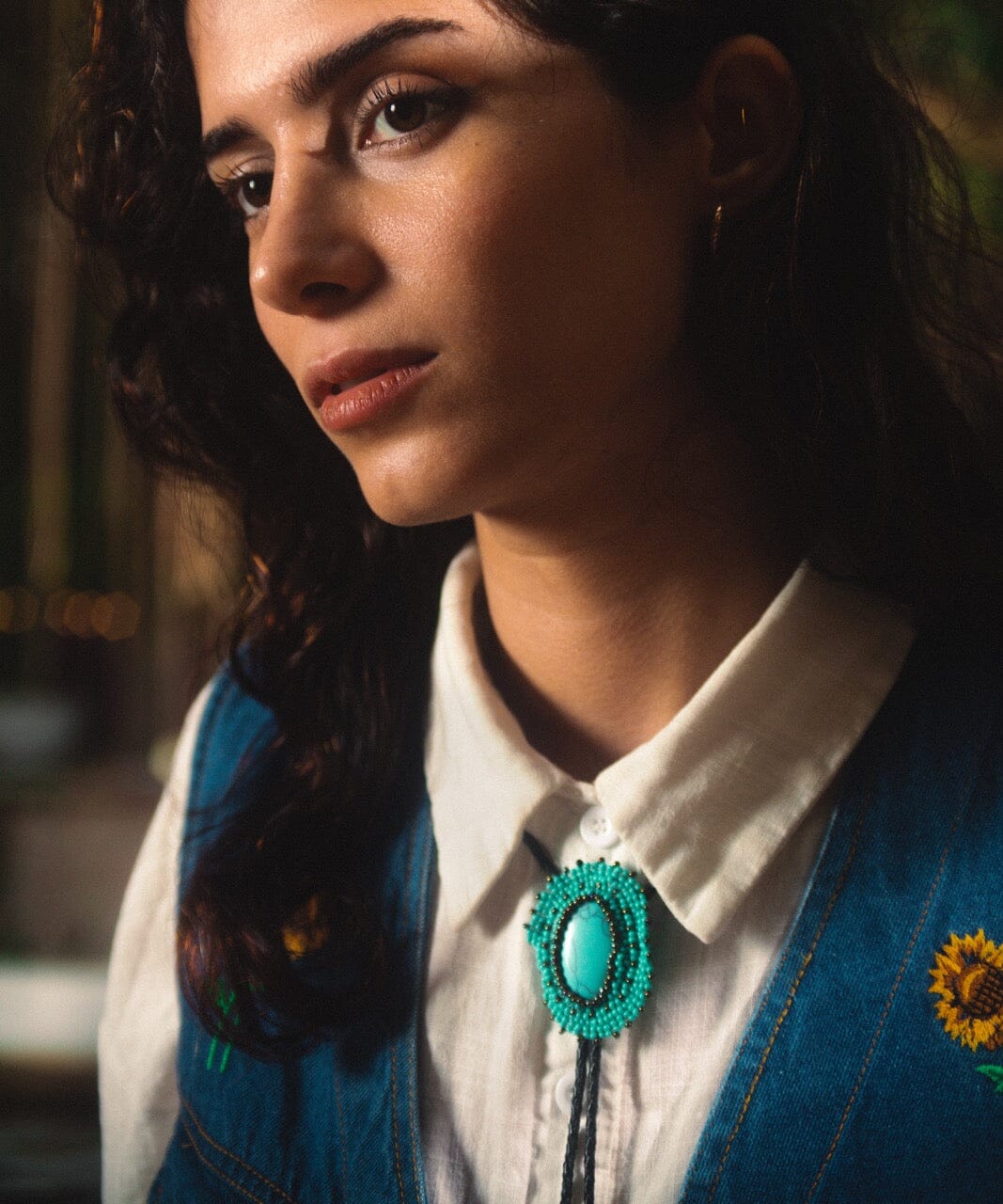 Woman Wearing a Handmade Eilat Stone Turquoise Beaded Bolo Tie Necklace Necktie