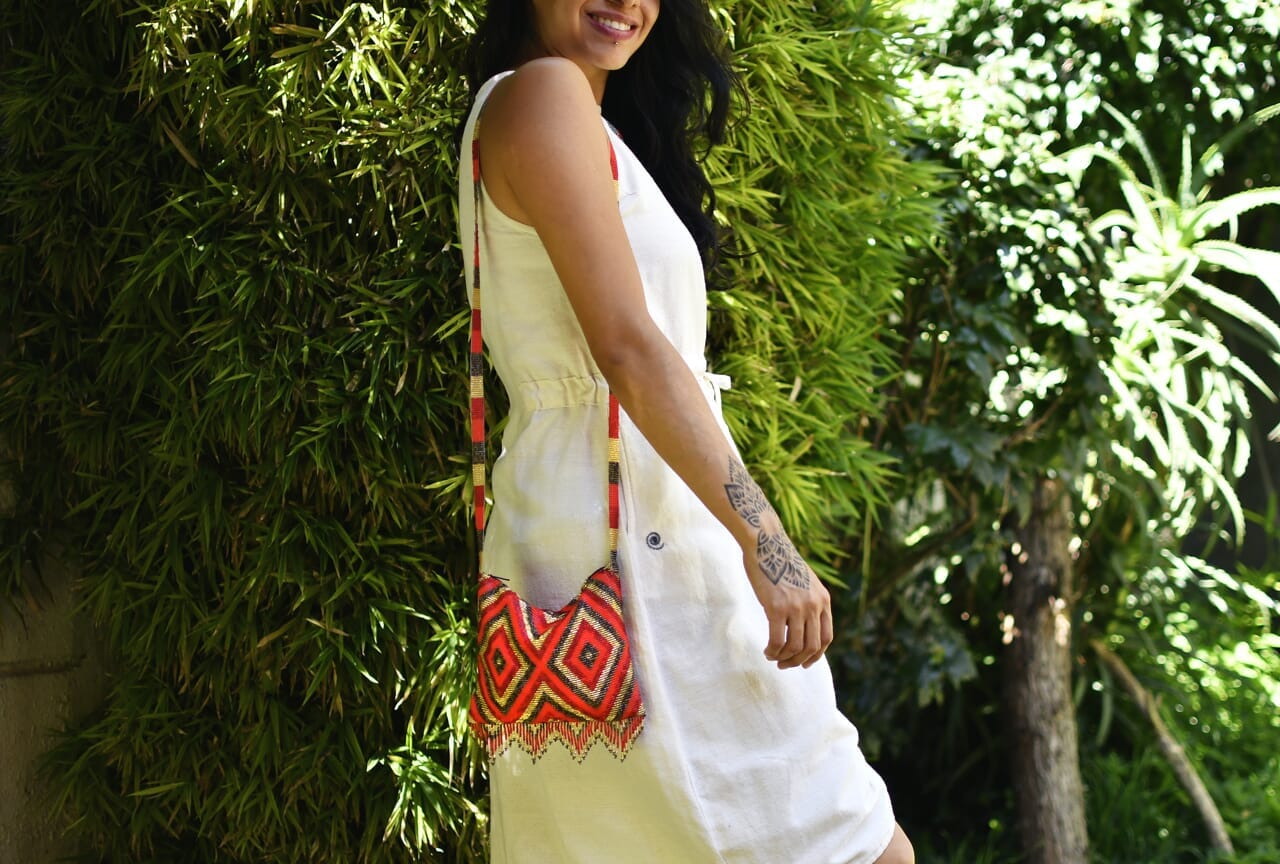 woman wearing red gold diamond pattern beaded purse bag fringe