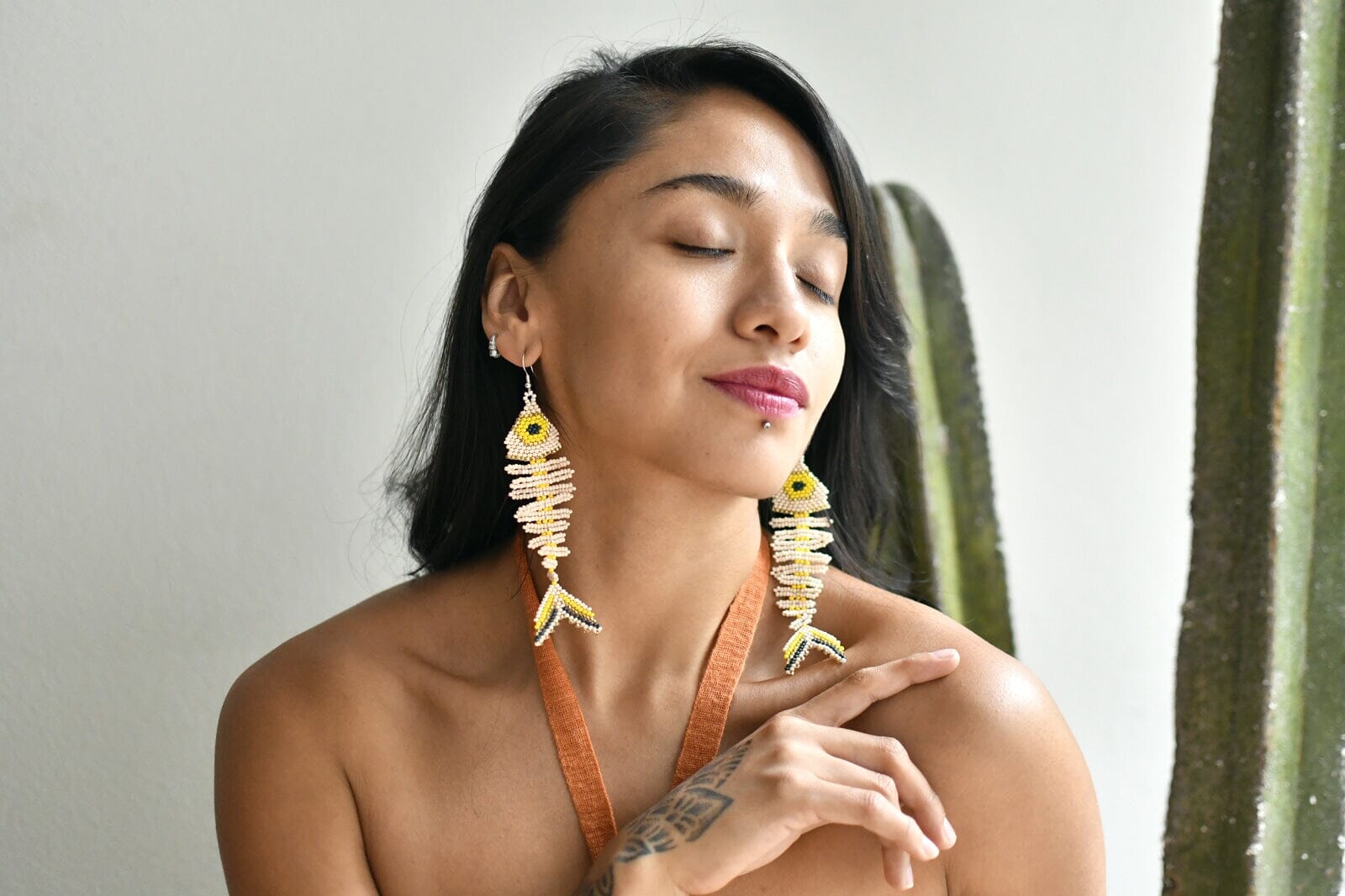 Woman Wearing Bone White Yellow Fish Skeleton Laguna Handmade Beaded Earrings