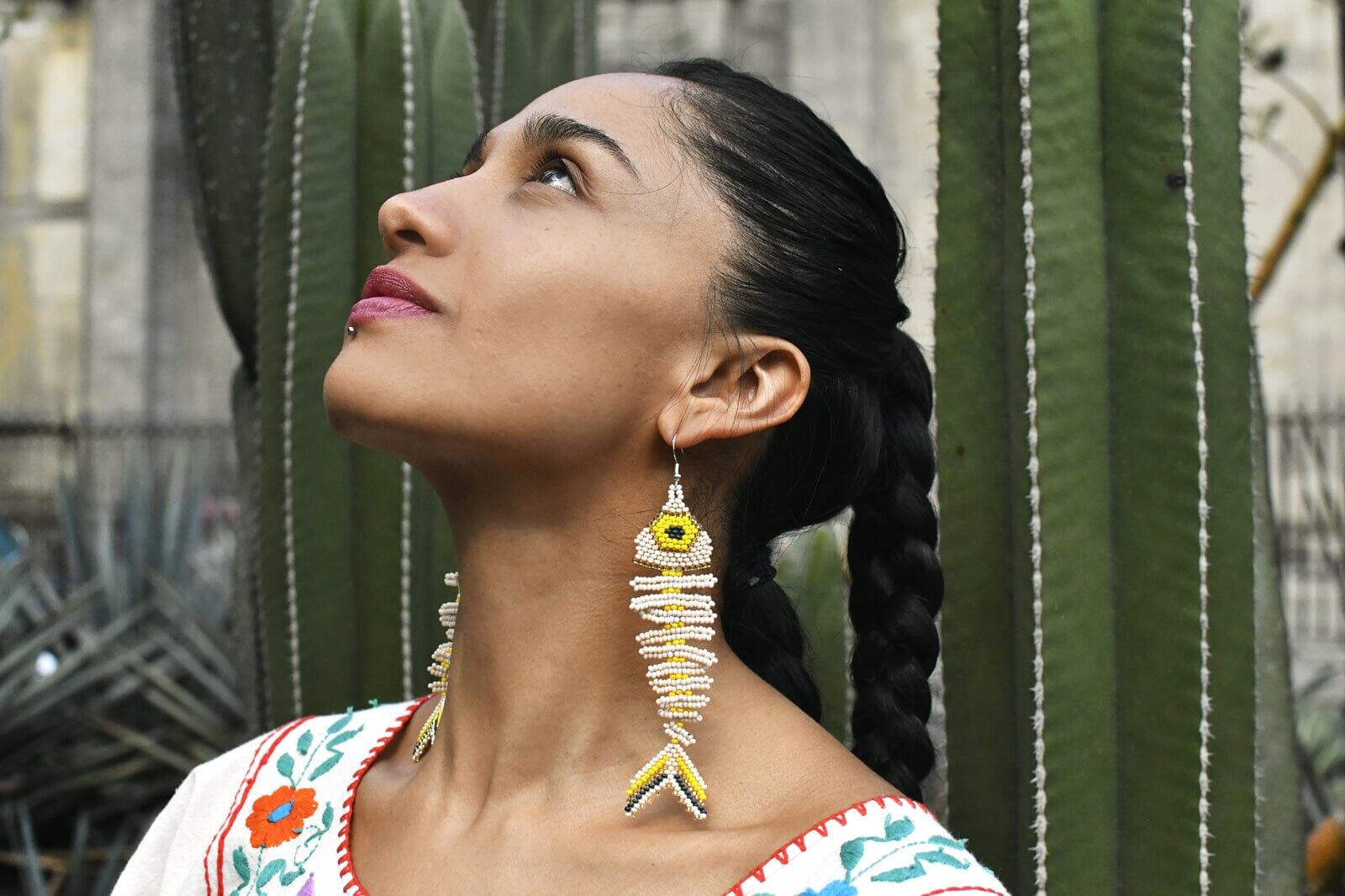 Woman Wearing a Elegant Handmade Bone White Yellow Fish Skeleton Laguna Beaded Earrings