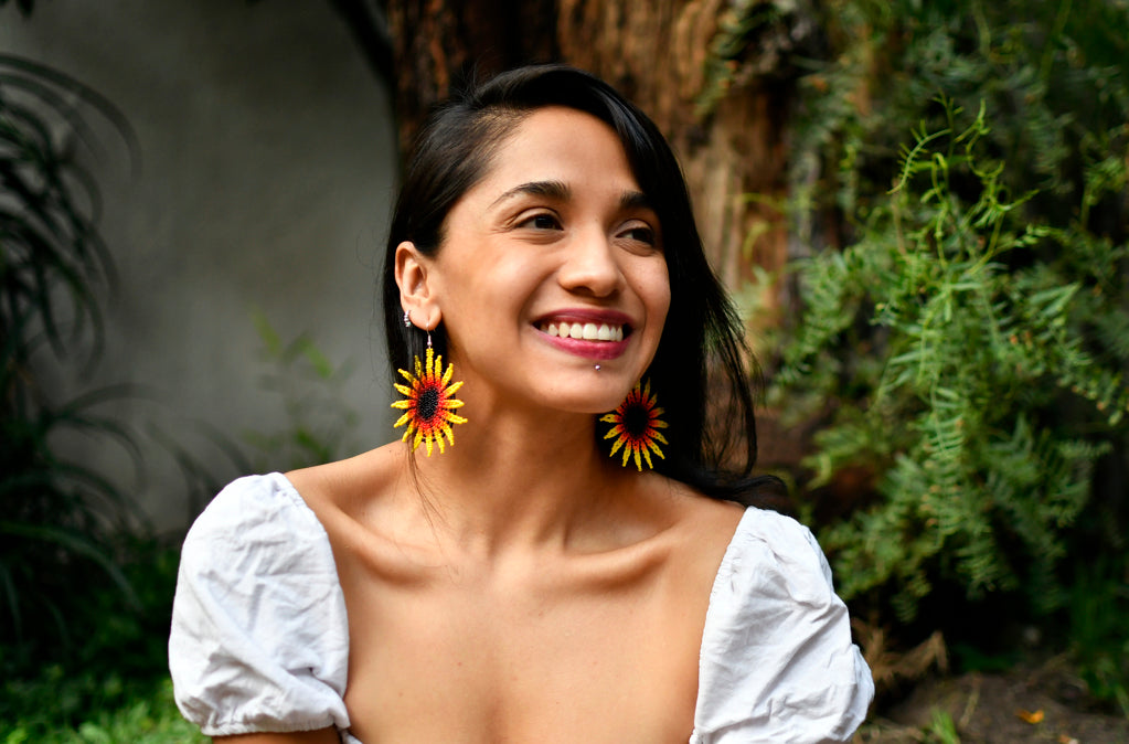 Woman Wearing Flower Blossom Round Handmade Beaded Earrings by Mother Sierra