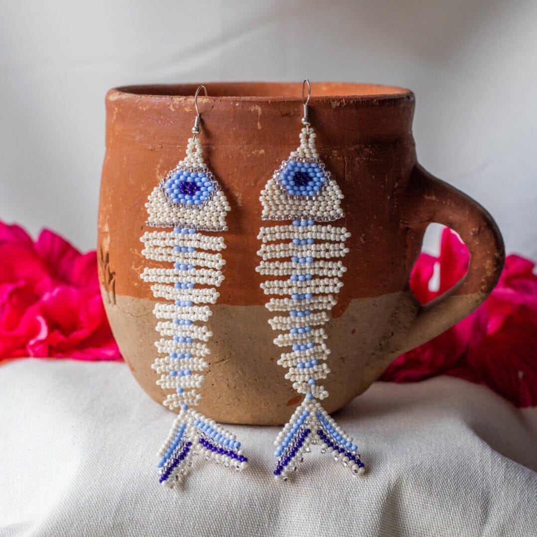 Pearl Of The Nile soft blue fish skeleton fossil beaded earrings