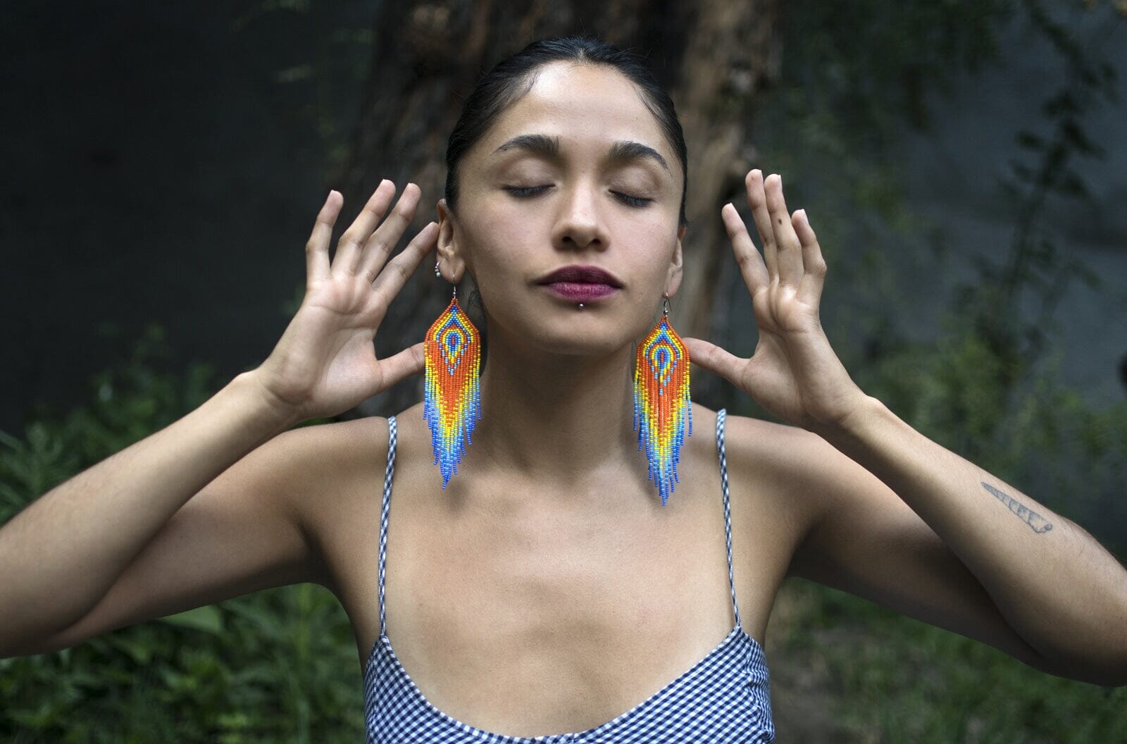 woman wearing orange yellow light blue vibrant fringe handmade beaded earrings