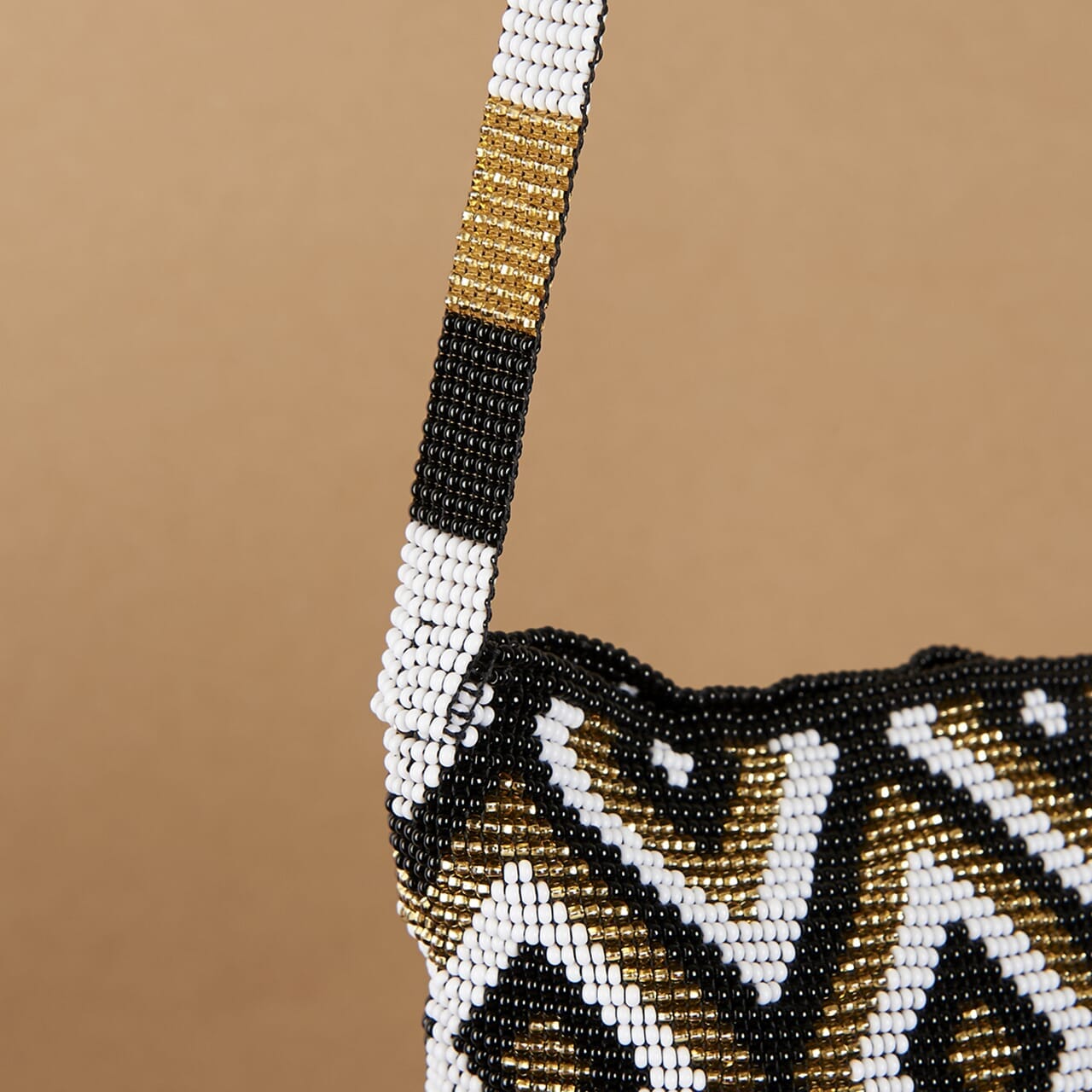 close up of white gold black diamond beaded purse bag fringe