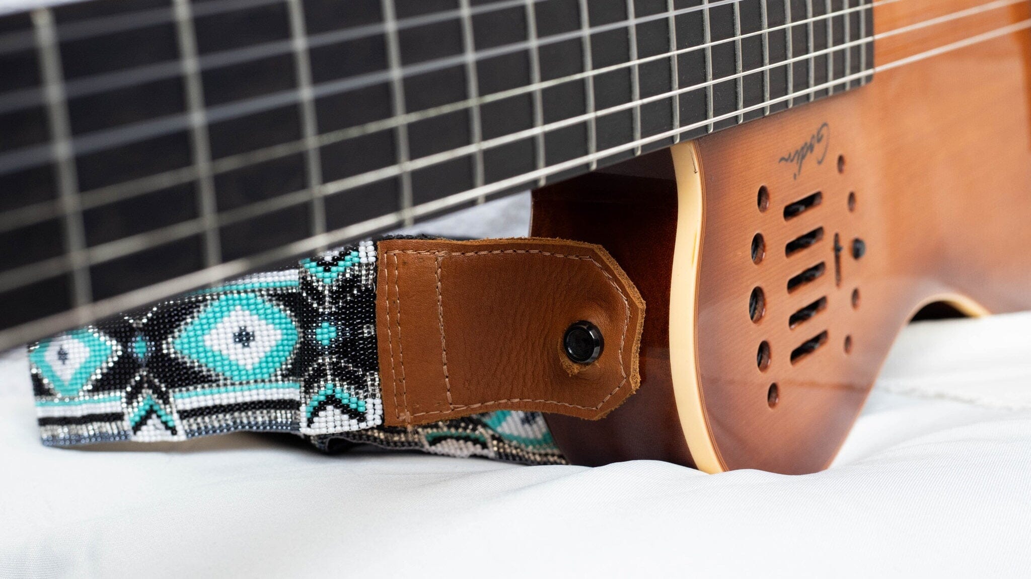 close up Super Nova beaded guitar strap white black teal silver adjustable leather on guitar