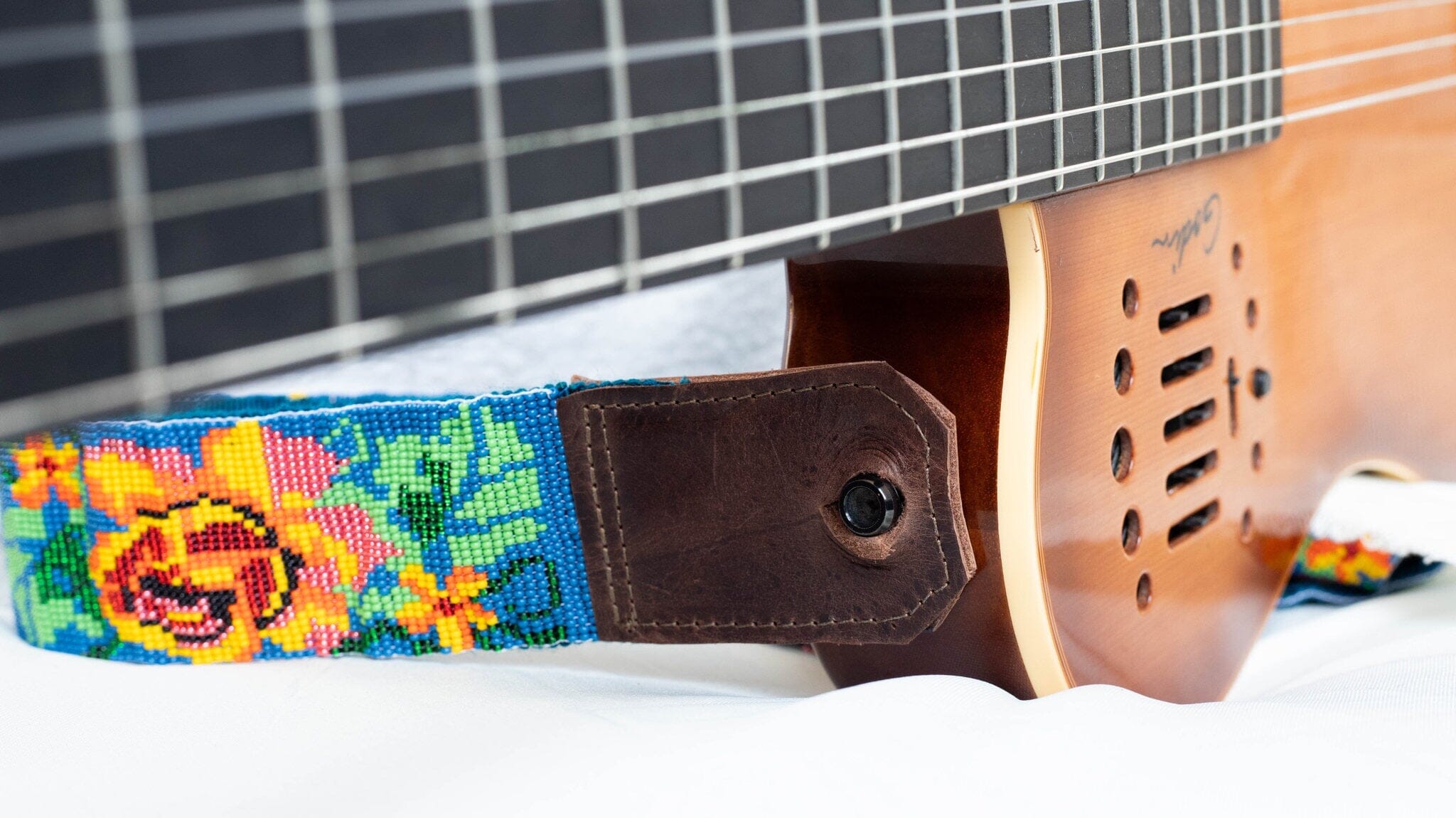 close up Texas Rose beaded Guitar Strap blue pink yellow green adjustable leather on guitar