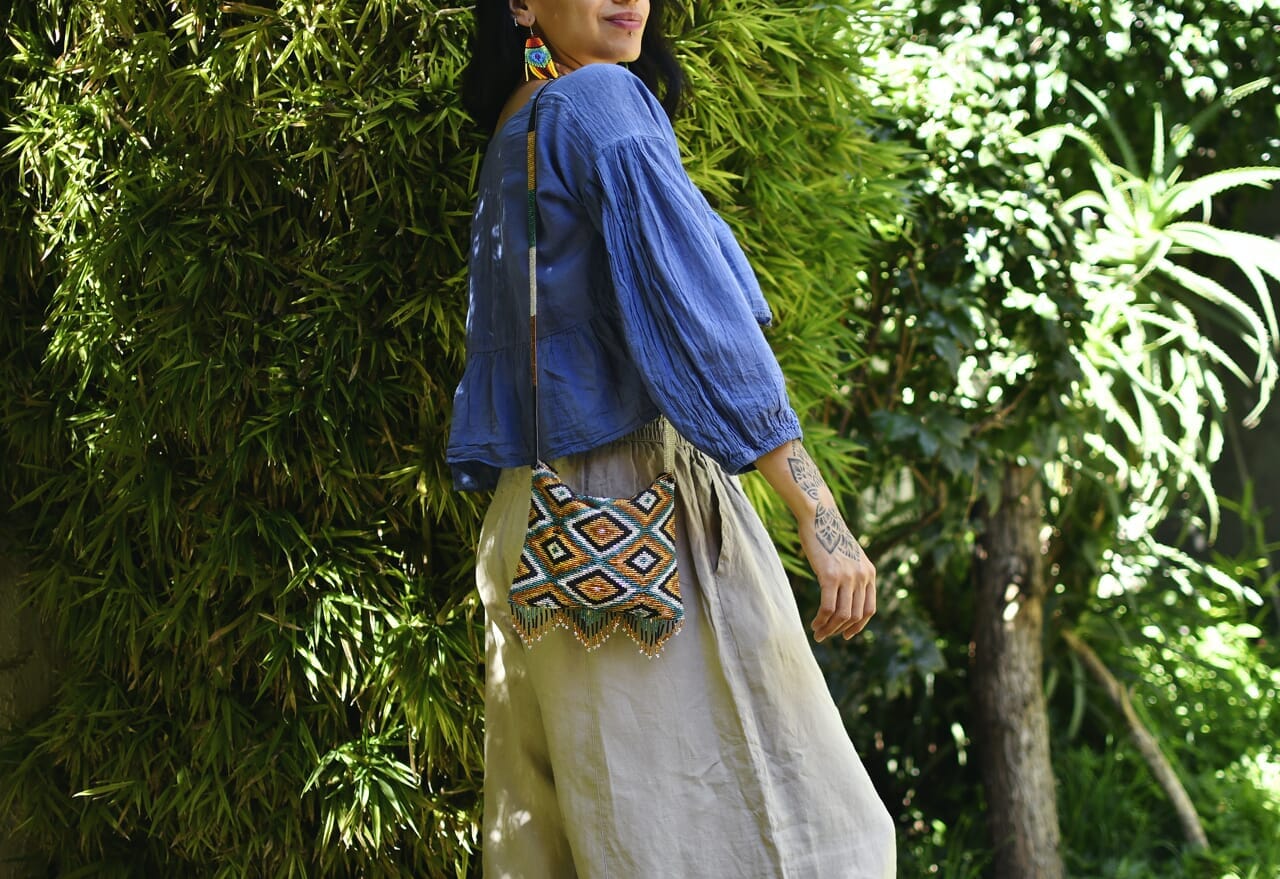 woman wearing gold teal black silver diamond beaded purse bag fringe