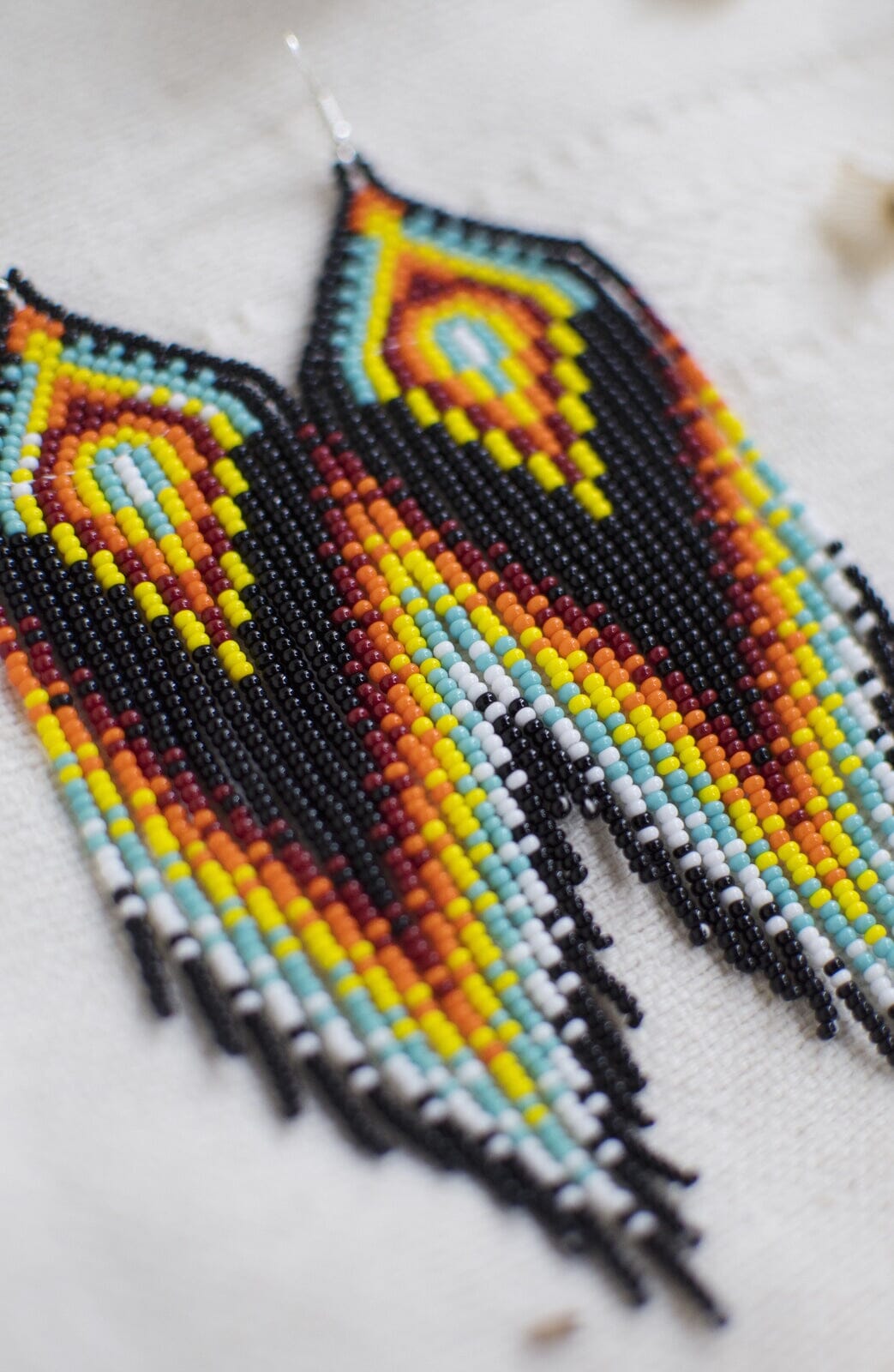 black fire teal white red icy hot fringe beaded earrings close up