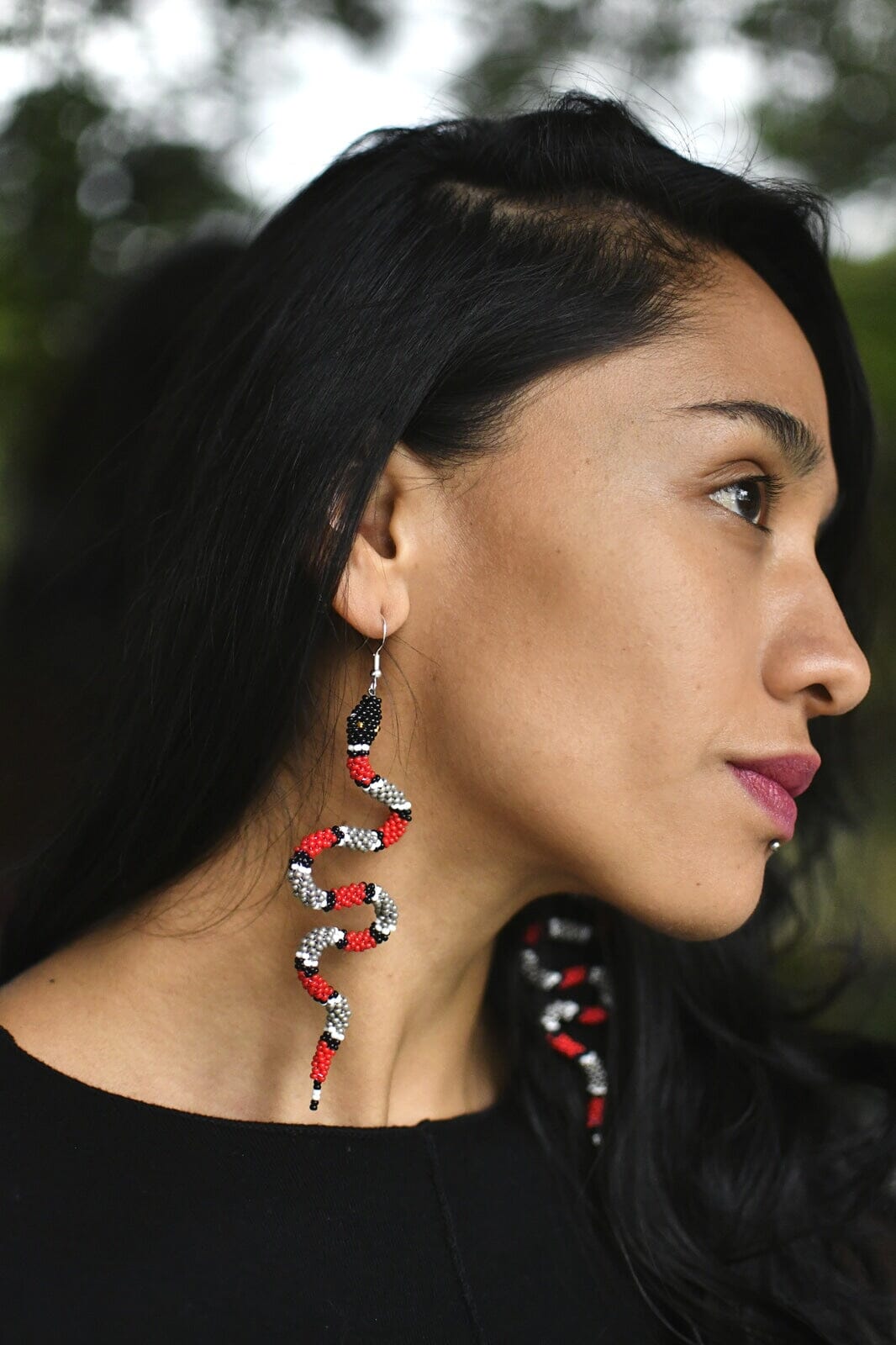 woman wearing Zelda red slithering snake beaded earrings
