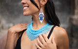 woman wearing azore blue beaded scarf choker necklace native american jewelry and blue hamsa beaded earrings