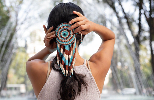 woman wearing cream tiara round light blue brown white beaded hair barrette and pin statement piece native american jewelry