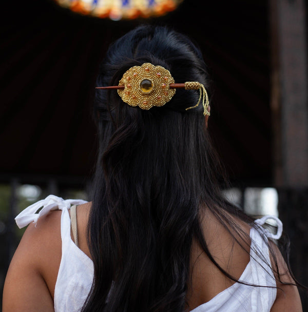 woman wearing golden nugget gold beaded hair barrette and pin statement piece native american jewelry