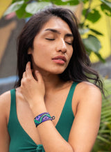 woman wearing Orpheus purple snake green beaded bracelet cuff
