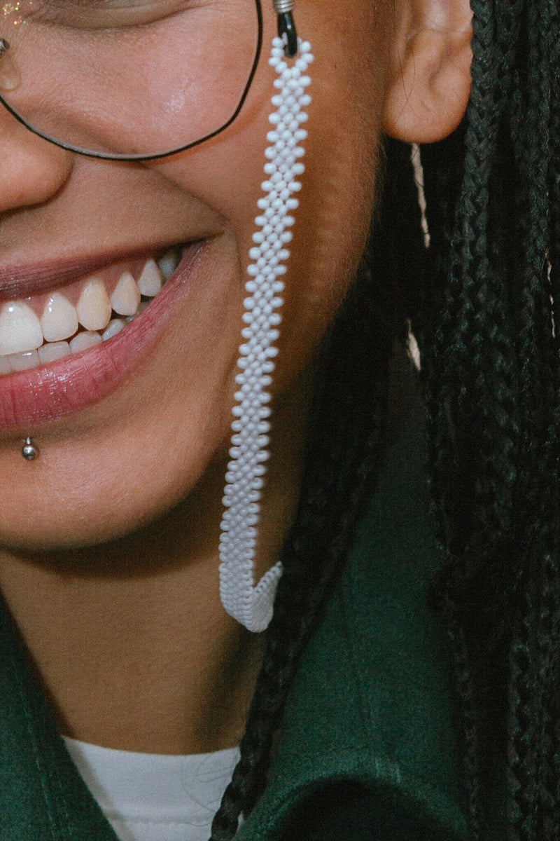 pearly whites white beaded glasses chain jewelry close up