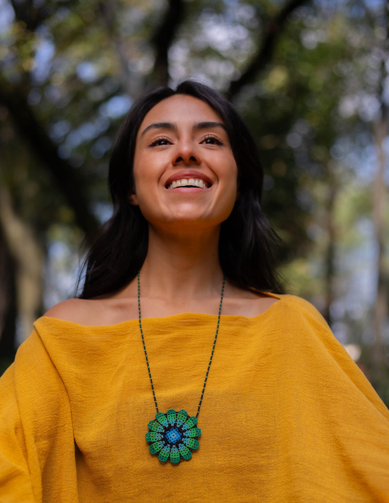 woman wearing selva green blue black beaded necklace emblem native american jewelry