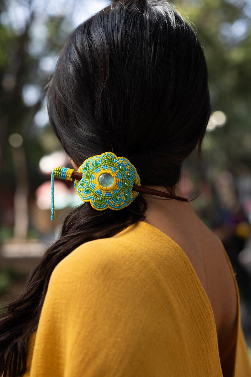 woman wearing sky high blue yellow green beaded hair barrette and pin statement piece native american jewelry