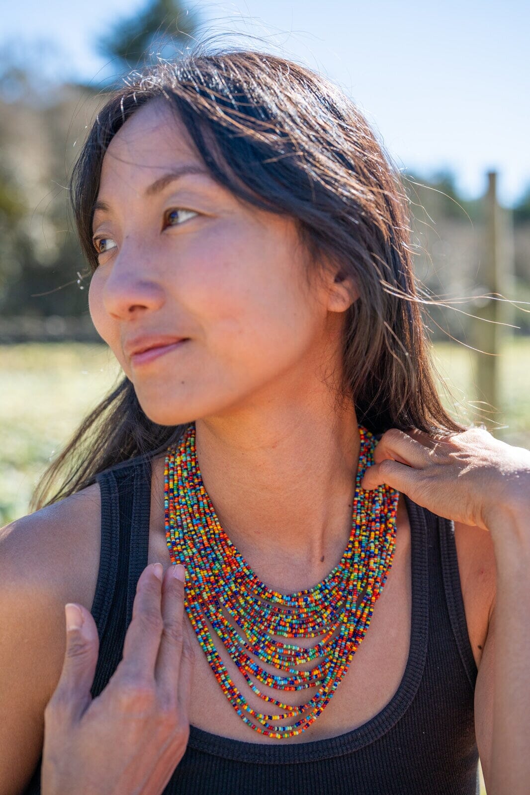 woman wearing Sugar and Spice beaded Necklace multi-strand rainbow red blue orange yellow green native american jewelry  Mother Sierra 