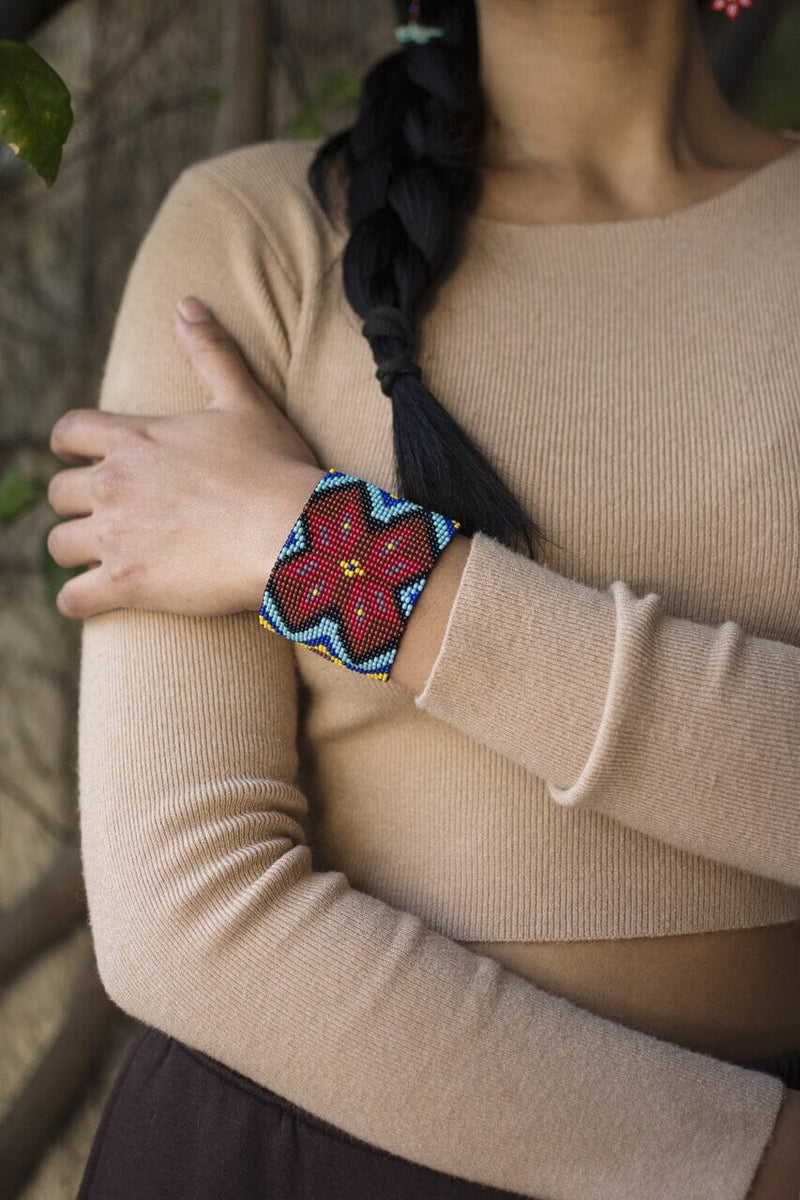 woman wearing Aztec Red pattern blue yellow black beaded bracelet cuff