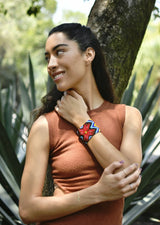 woman wearing Aztec Red pattern blue yellow black beaded bracelet cuff in forest