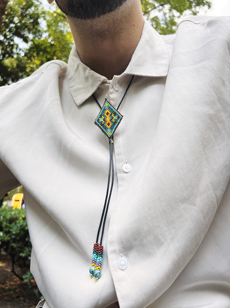 man wearing diamond spur beaded bolo tie brown teal yellow necktie necklace native american jewelry