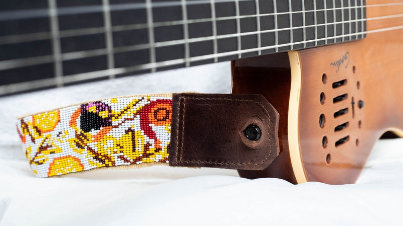 close up El Mercado beaded Guitar strap white yellow brown red orange adjustable leather on guitar 