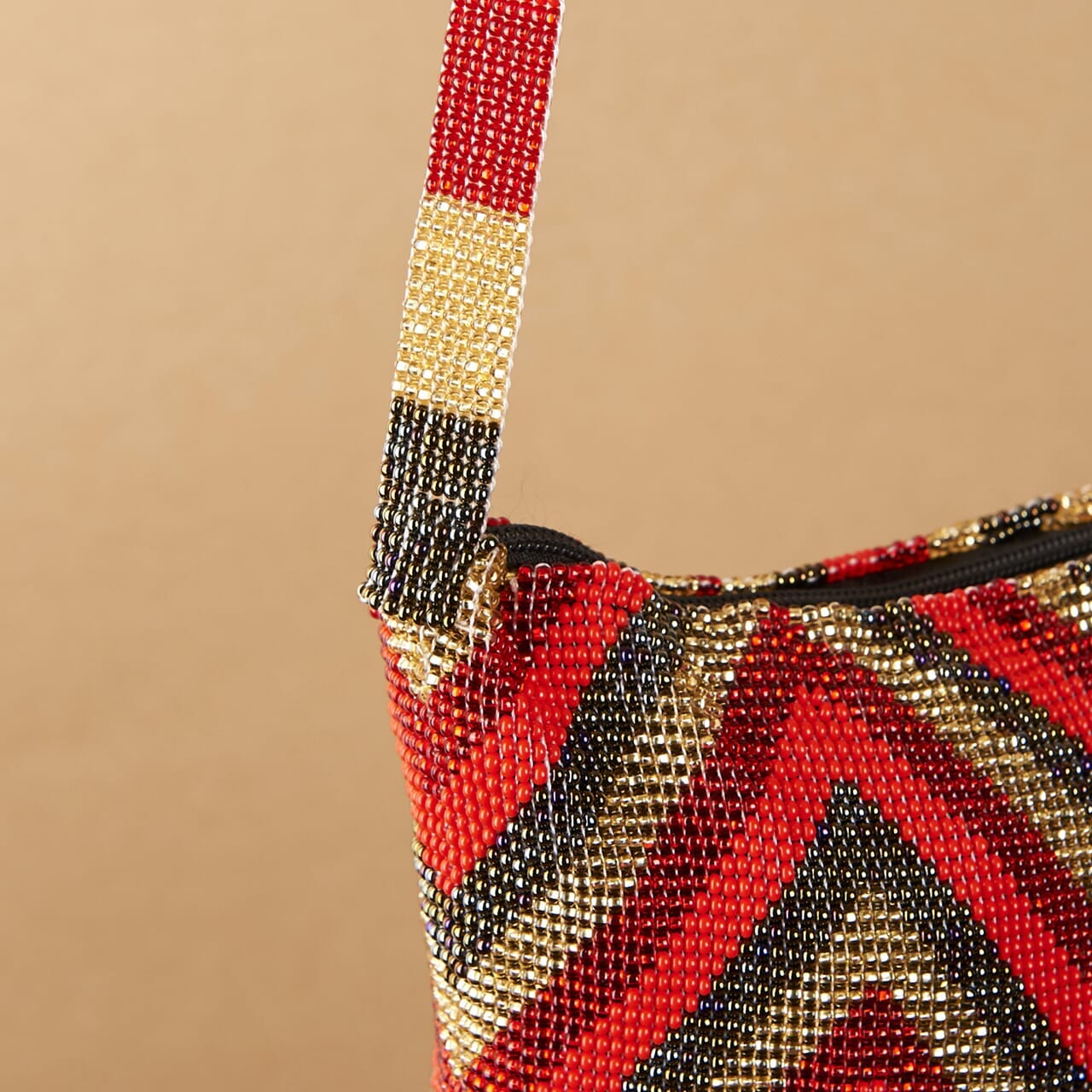 close up red gold diamond pattern beaded purse bag fringe