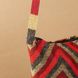 close up red gold diamond pattern beaded purse bag fringe