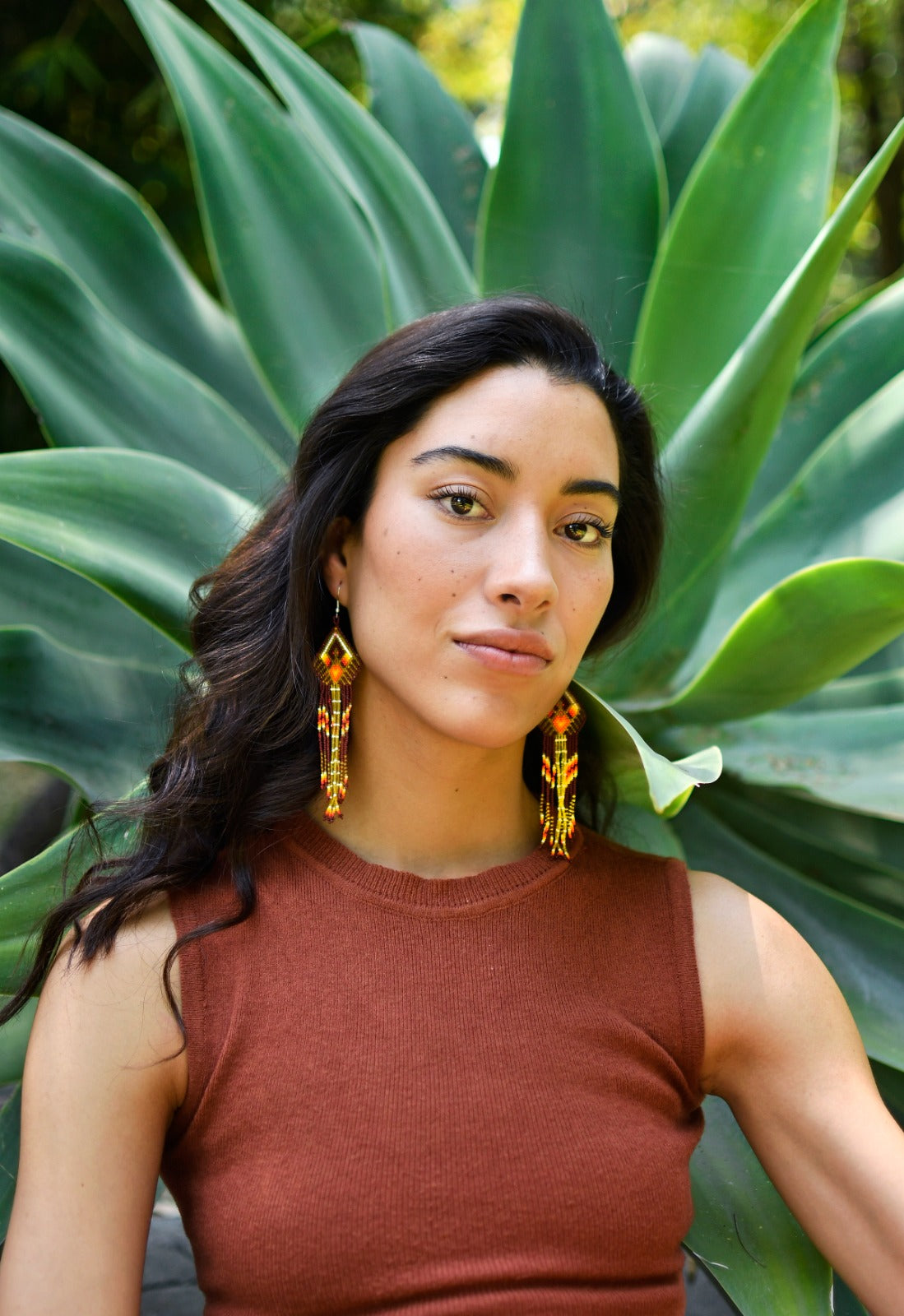 Woman Wearing a Handmade Golden Brown Fringe Native American Beaded Earrings by Mother Sierra