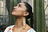 woman wearing bone white yellow fish skeleton laguna beaded earrings