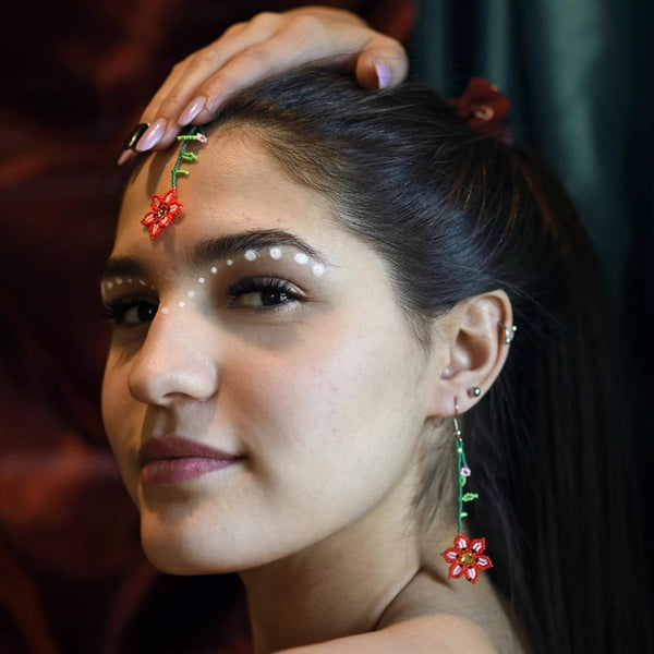 woman wearing red pink green flower dangle beaded earrings