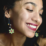 woman wearing light blue yellow pink flower dangle beaded earrings