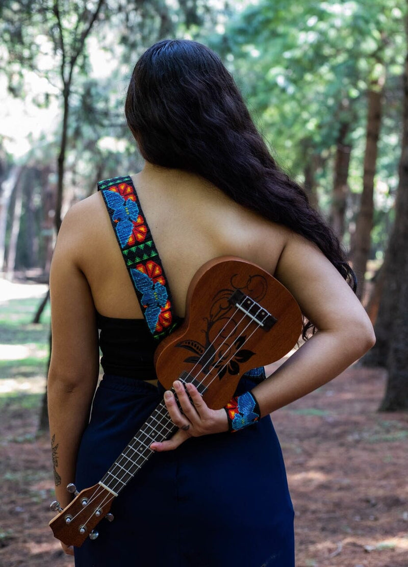 woman wearing Rising Glory blue dove beaded Guitar Strap black red yellow green adjustable leather on ukulele