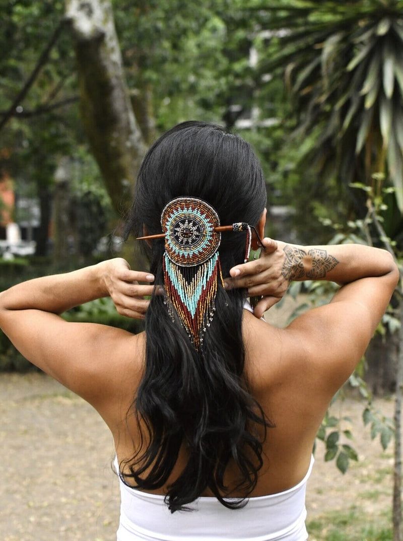 woman wearing tiara round blue gold brown beaded hair barrette and pin statement piece native american jewelry