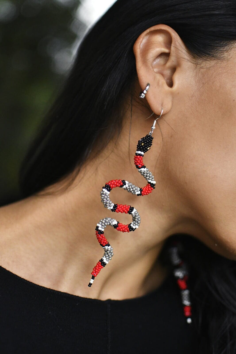woman wearing Zelda red slithering snake beaded earrings 